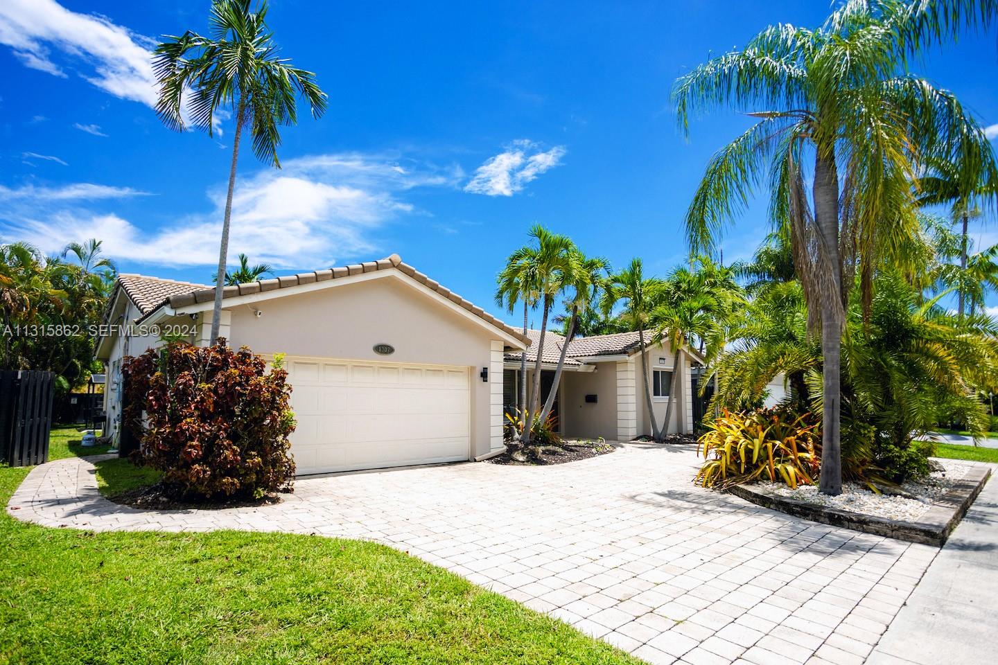 1307 Rodman Street Hollywood, FL 33019 - Photo 6 of 38 a front view of a house with garden