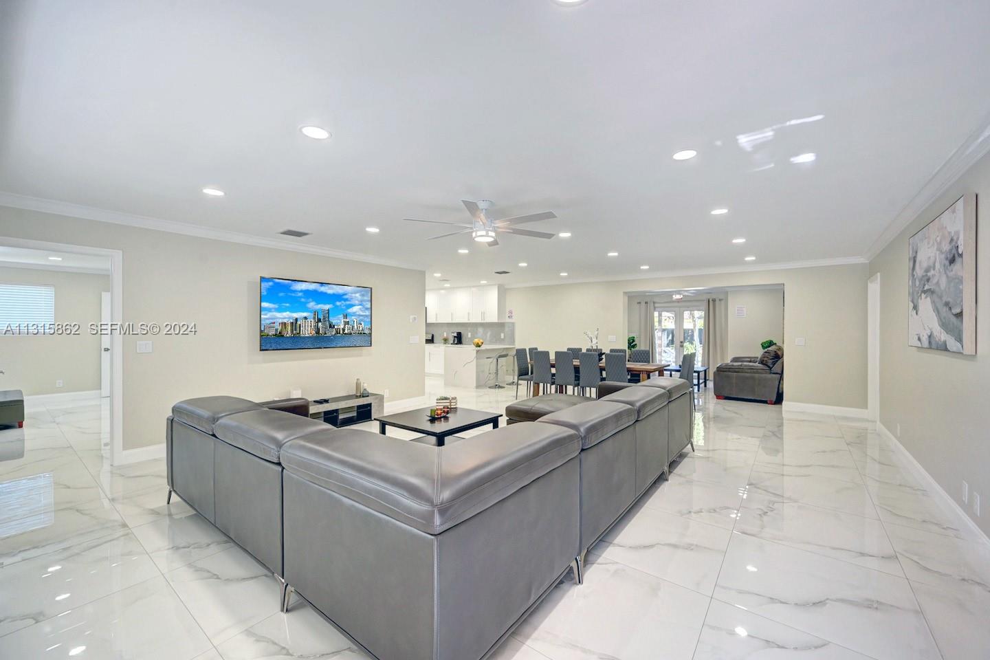 1307 Rodman Street Hollywood, FL 33019 - Photo 9 of 38 a living room with couches and kitchen view with wooden floor