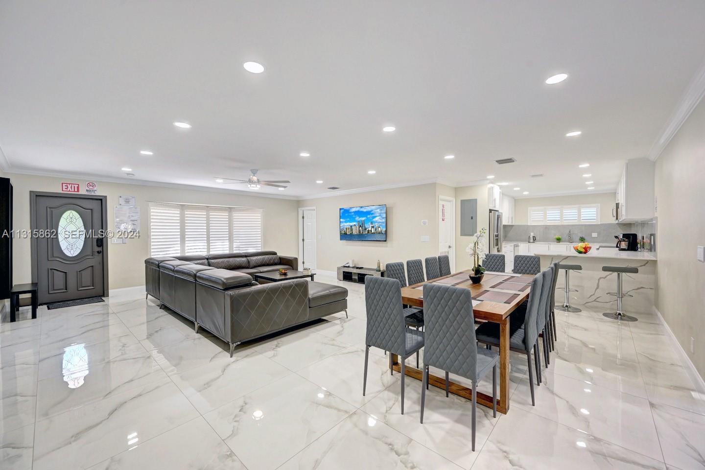 1307 Rodman Street Hollywood, FL 33019 - Photo 10 of 38 a kitchen with a table and chairs in it