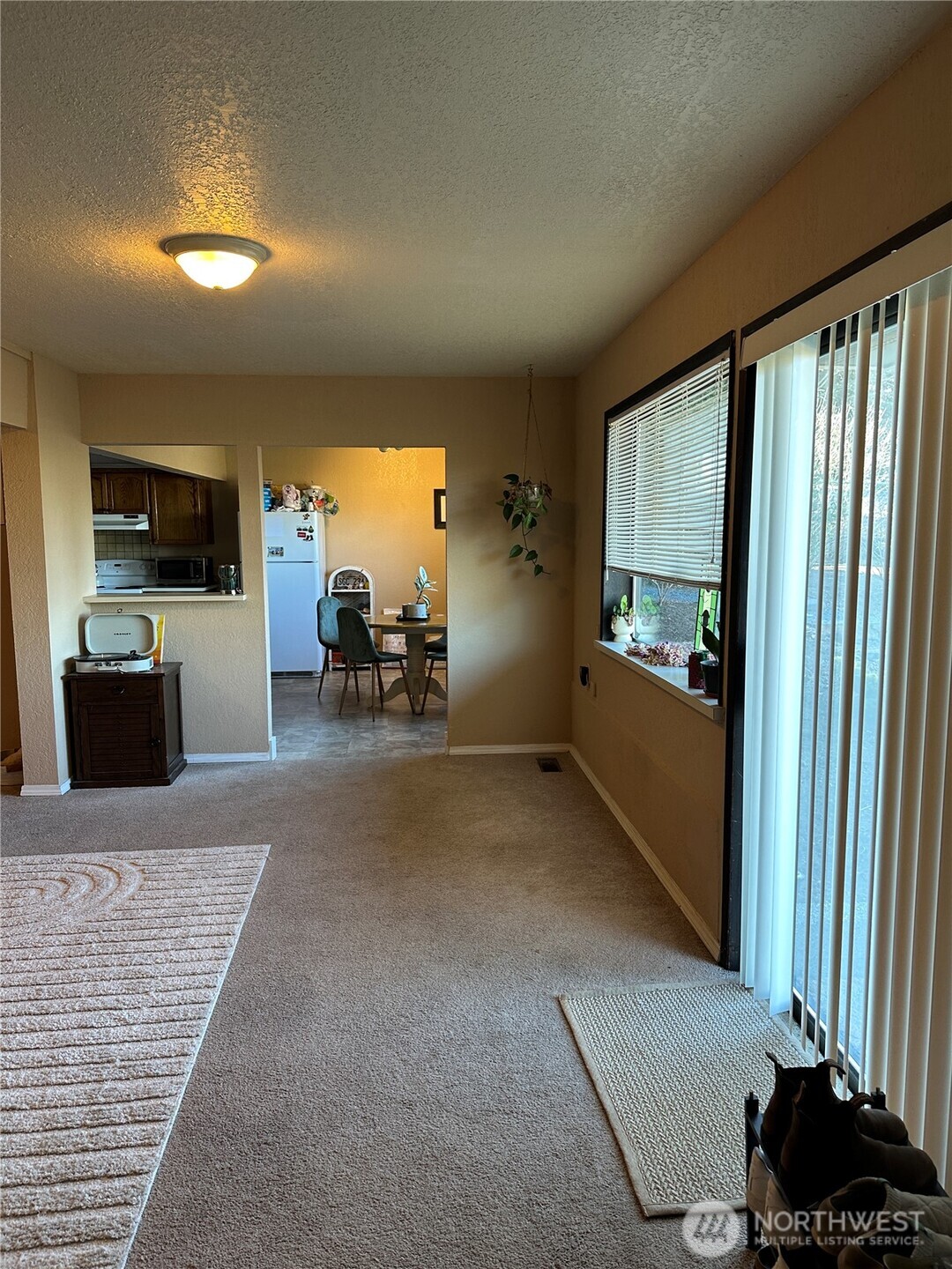 520 Olympic Avenue, Unit B Edmonds, WA 98020 - Photo 3 of 18 a living room with furniture a flat screen tv and a large window