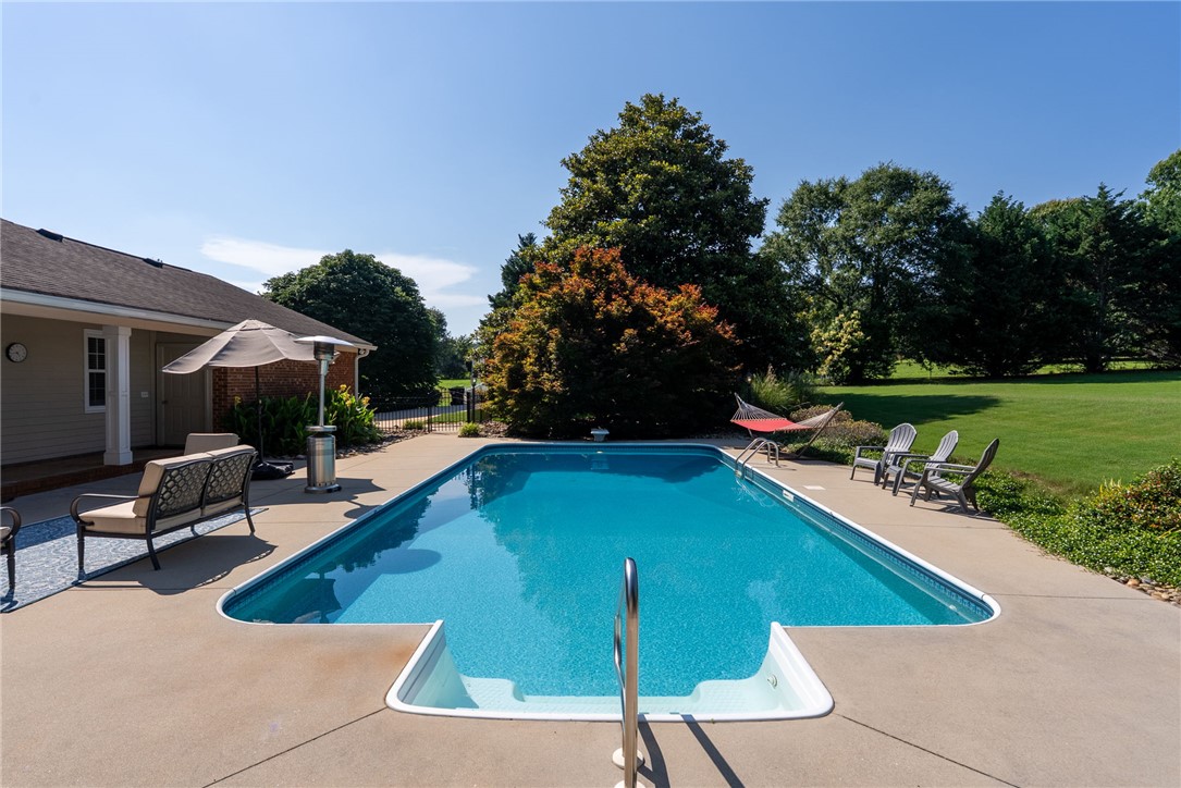 3513 Hopewell Road Anderson, SC 29621 - Photo 35 of 50 An inviting backyard oasis offers a sparkling in-ground pool and ample space for outdoor relaxation.