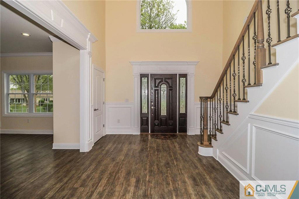 23 Windsor Road Edison, NJ 08817 - Photo 5 of 25 a view of hallway with wooden floor and stairs