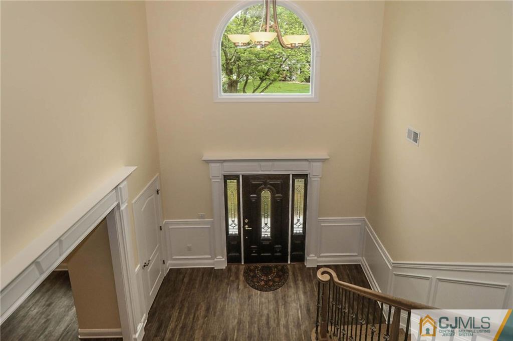 23 Windsor Road Edison, NJ 08817 - Photo 6 of 25 a view of a hallway with wooden floor and a window