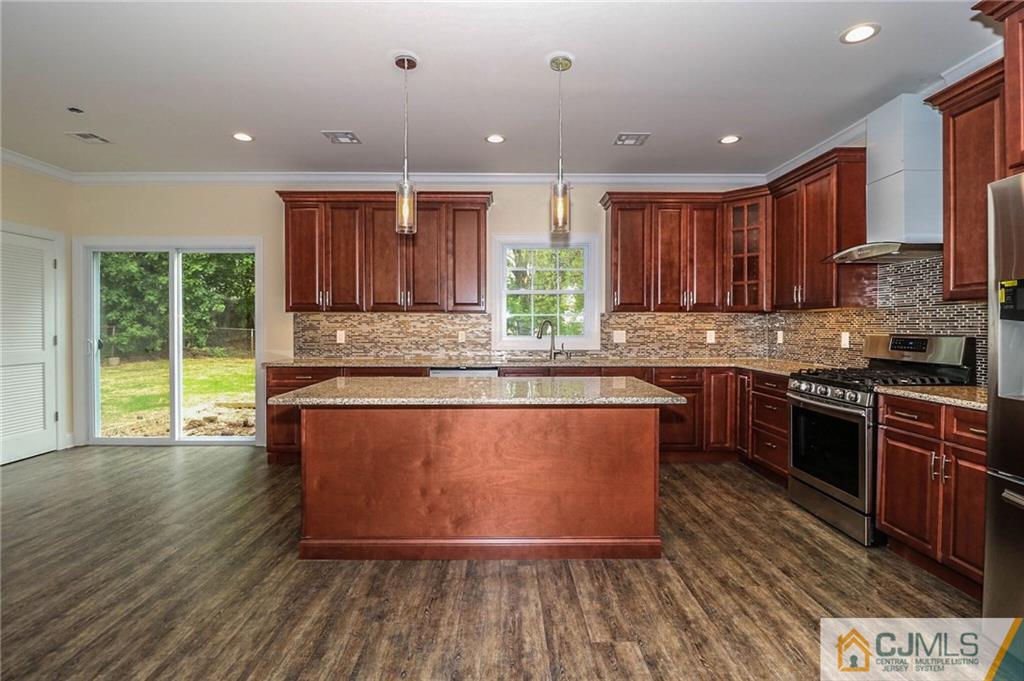 23 Windsor Road Edison, NJ 08817 - Photo 9 of 25 a kitchen with stainless steel appliances granite countertop a stove a sink and a microwave