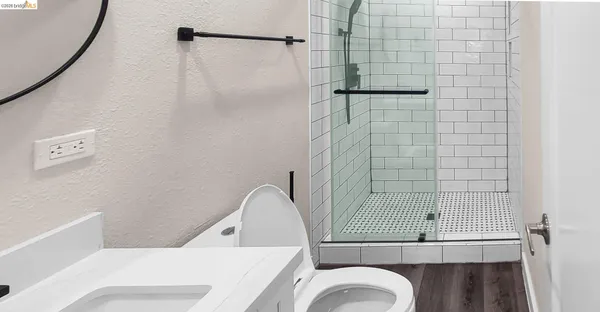 a view of a pathway of a house with wooden fence