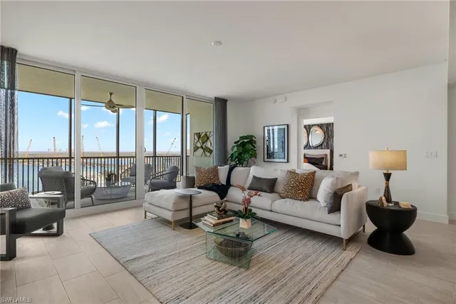 a kitchen with stainless steel appliances granite countertop a sink a stove a refrigerator and island