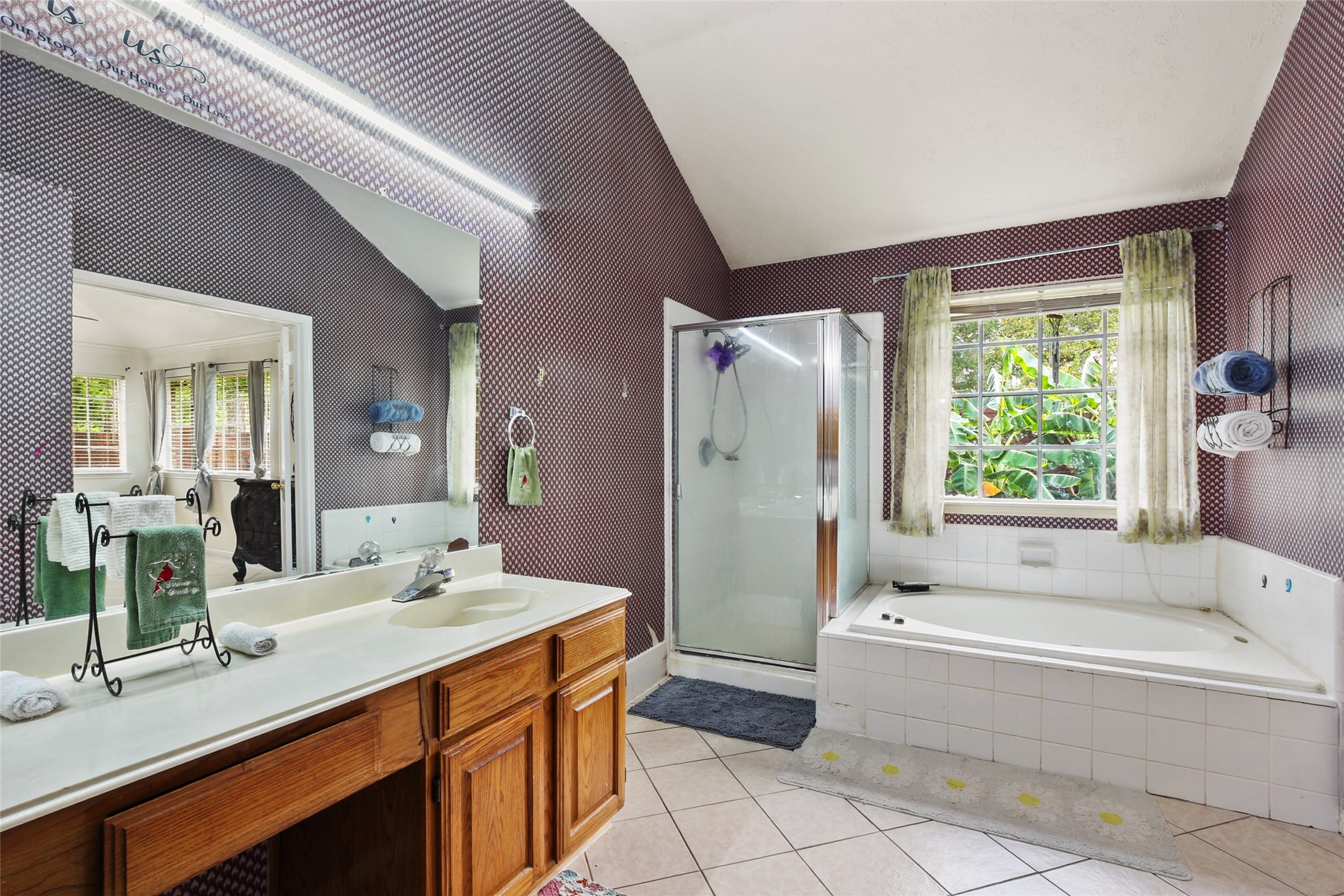 14554 Sycamore Lake Road Houston, TX 77062 - Photo 13 of 17 a bathroom with a granite countertop sink mirror bathtub and next to a window