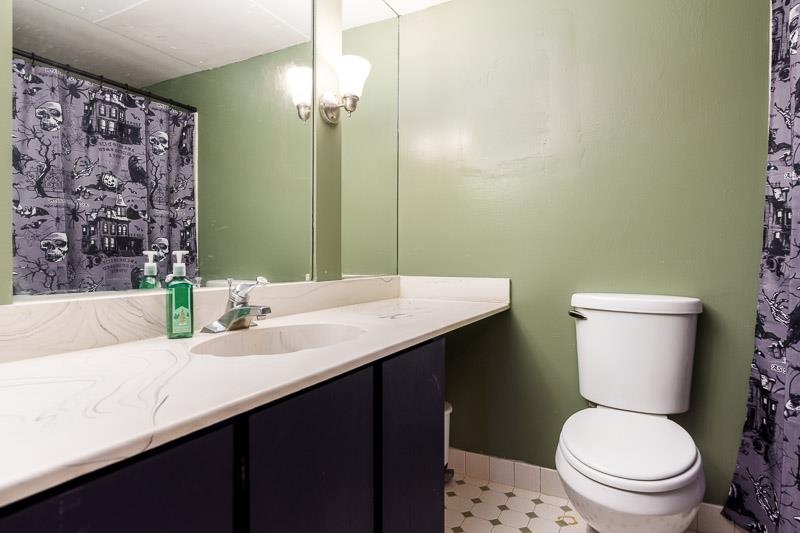 20110 Grade School Road Caledonia, IL 61011 - Photo 20 of 39 a bathroom with a granite countertop toilet sink and a mirror