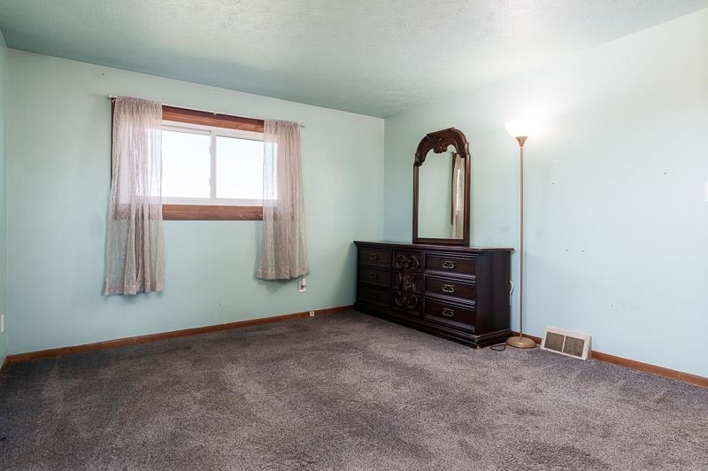 20110 Grade School Road Caledonia, IL 61011 - Photo 24 of 39 an empty room with windows and cabinet