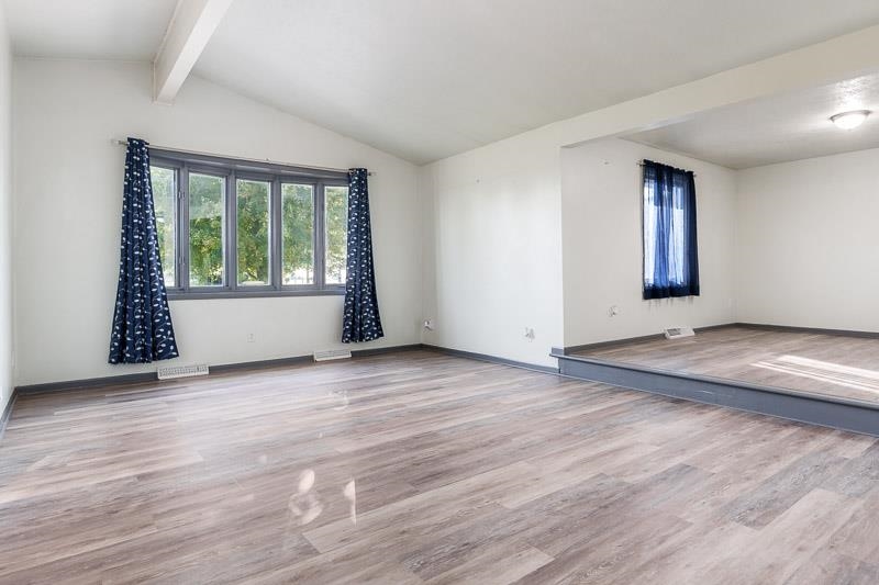 20110 Grade School Road Caledonia, IL 61011 - Photo 6 of 39 an empty room with wooden floor and windows