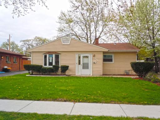 333 East Dennis Road Wheeling, IL 60090 - Photo 1 of 1 a front view of a house with a garden and yard