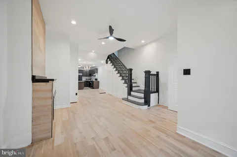 a view of entryway and hall with wooden floor