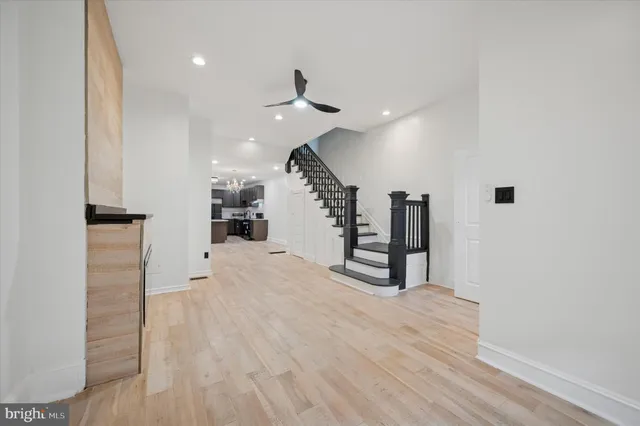a view of entryway and hall with wooden floor
