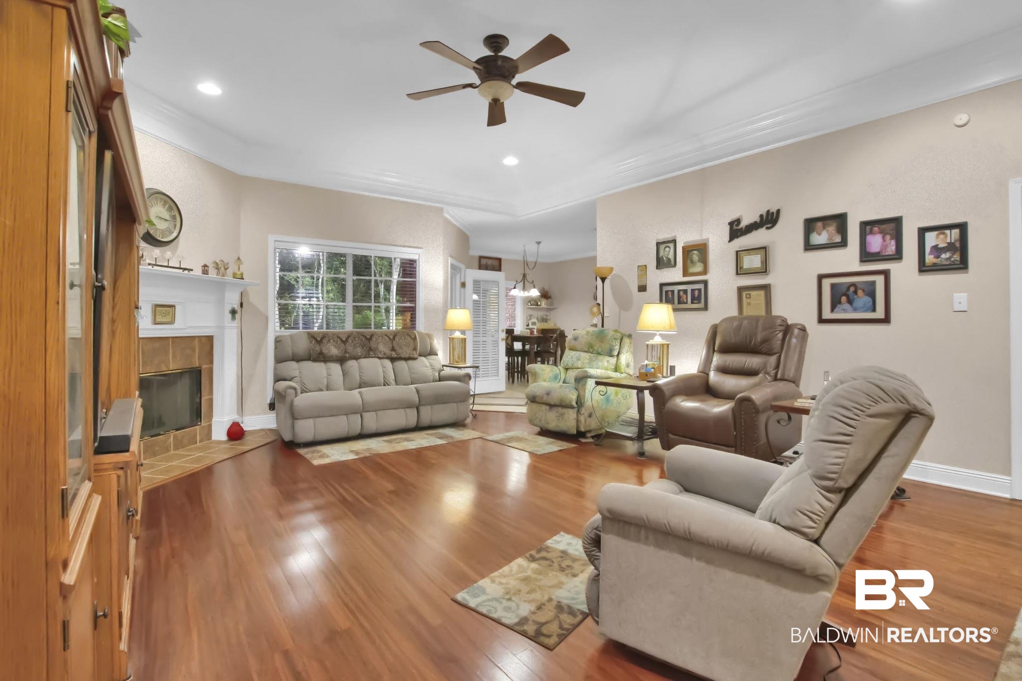 1 Bens Bluff Daphne, AL 36527 - Photo 9 of 56 Living room with crown molding, hardwood / wood-style flooring, ceiling fan, and a tile fireplace
