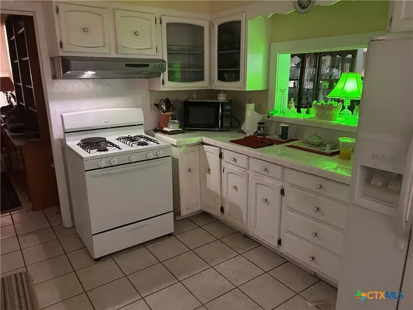 a kitchen with cabinets and appliances