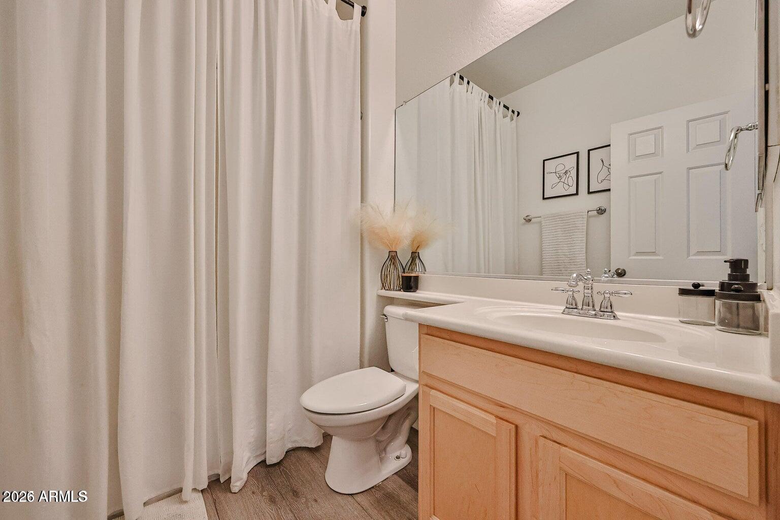3950 North Edith Way Buckeye, AZ 85396 - Photo 23 of 32 a bathroom with a granite countertop sink and a mirror
