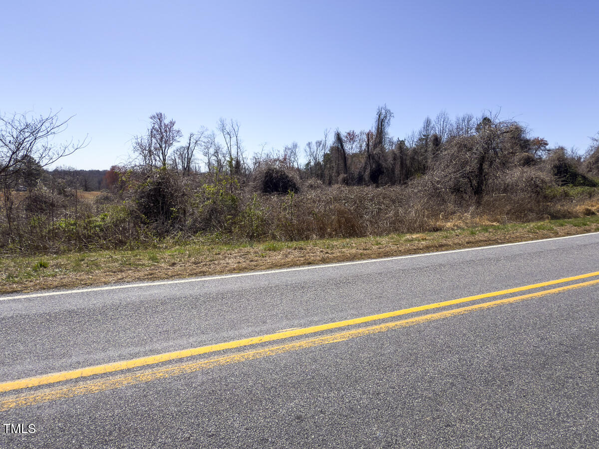 Lot 6 Goodman Road Pelham, NC 27311 - Photo 19 of 42 a view of a field with trees in the background