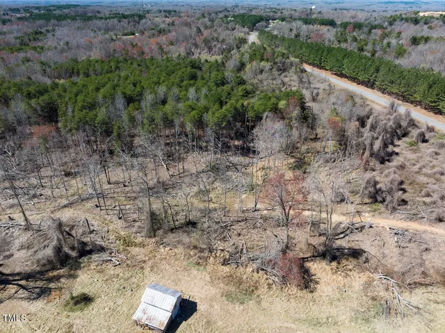 a view of a yard with trees in the background