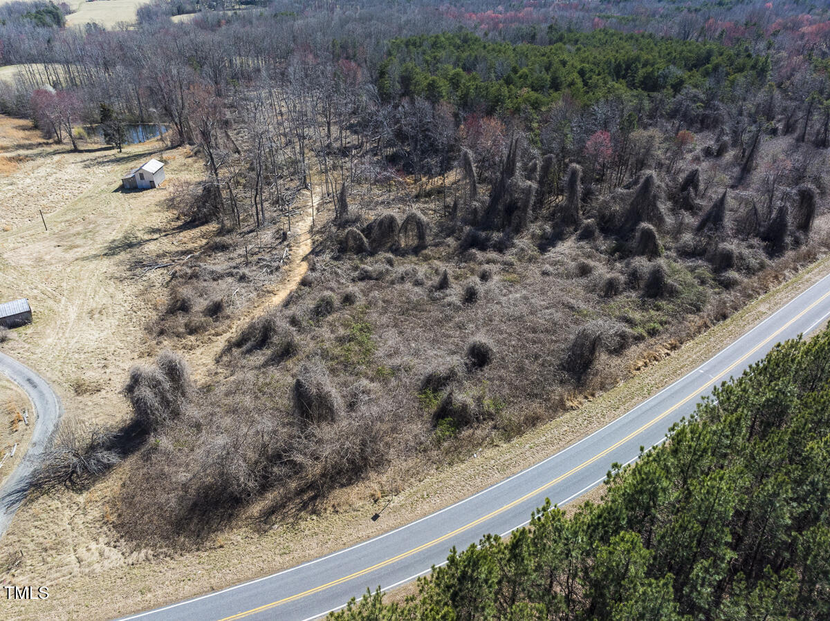 Lot 6 Goodman Road Pelham, NC 27311 - Photo 4 of 42 a view of a backyard with wooden fence