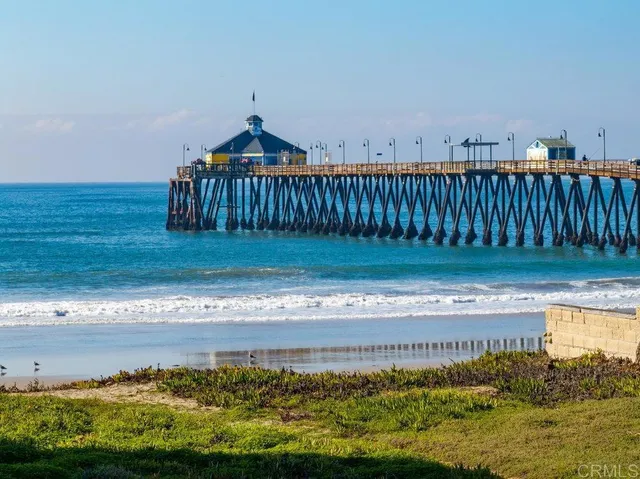 a view of a yard with wooden fence