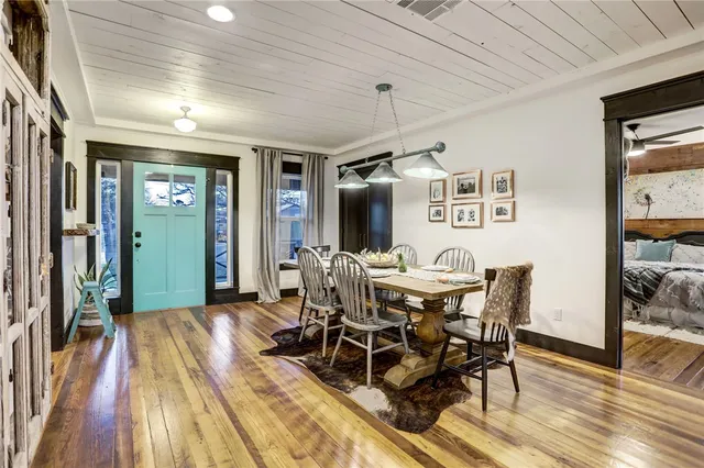 a view of a dining room with furniture and wooden floor