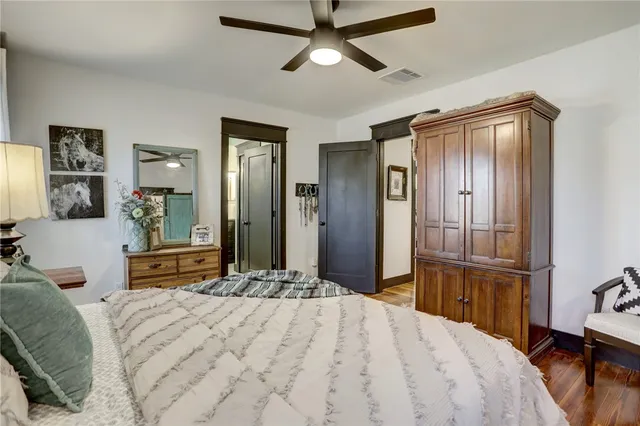 a bedroom with a large bed and a chandelier
