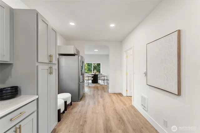 a open kitchen with white cabinets and stainless steel appliances