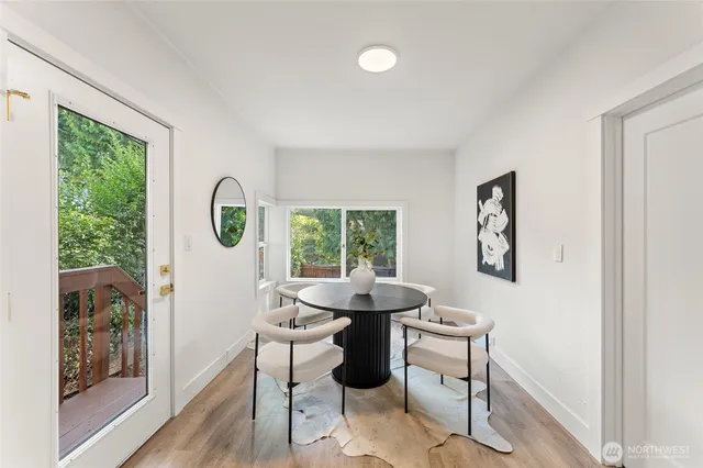 a dining room with furniture and a window