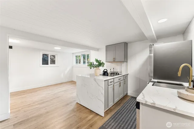 a kitchen with sink cabinets and wooden floor
