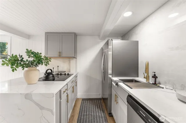 a kitchen with a sink and refrigerator