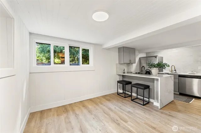 a view of kitchen with wooden floor and electronic appliances