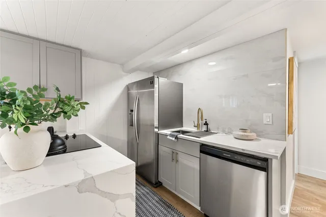 a bathroom with a sink a toilet and potted plant