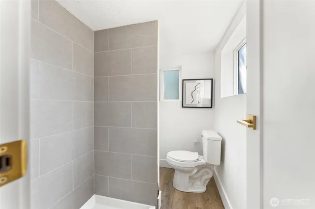 a white toilet sitting next to a bathroom sink
