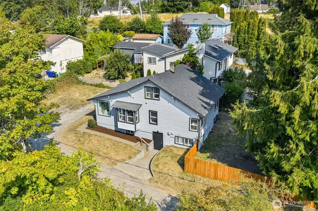 an aerial view of a house with a yard