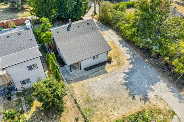 an aerial view of a house with a yard