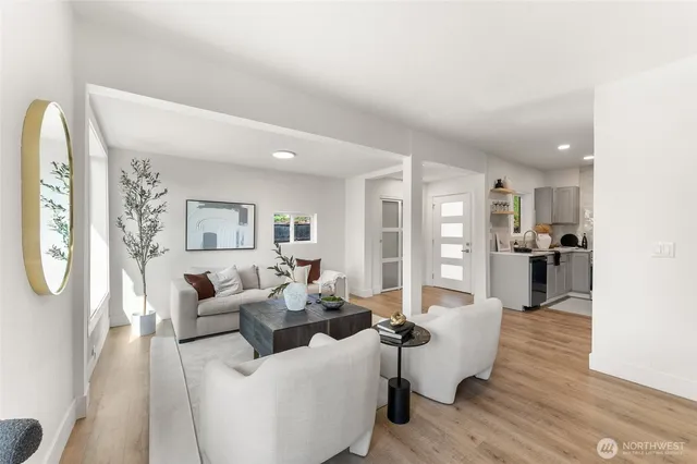 a living room with furniture wooden floor and a large window
