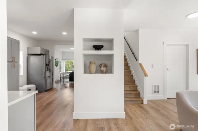 a view of a hallway with wooden floor windows and entryway