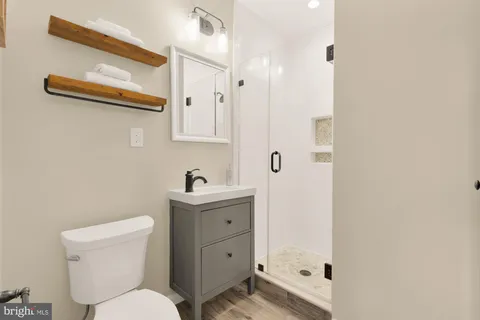 a white toilet sitting next to a bathroom sink
