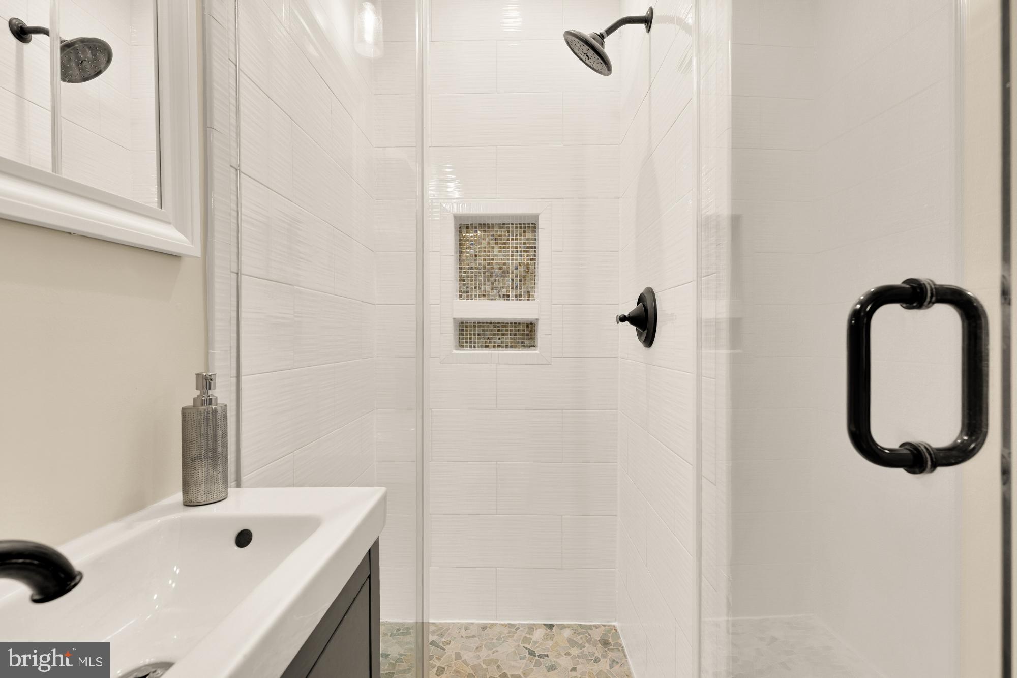 1112 Park Street Northeast Washington, DC 20002 - Photo 17 of 23 a bathroom with a tub a sink and mirror