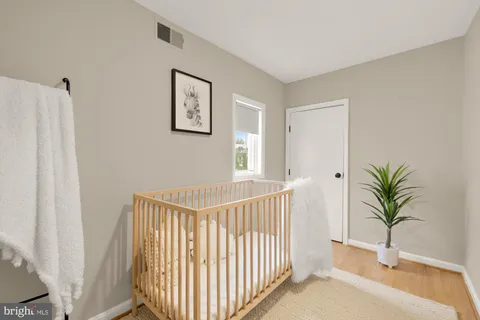 a view of a hallway and an entryway with wooden floor