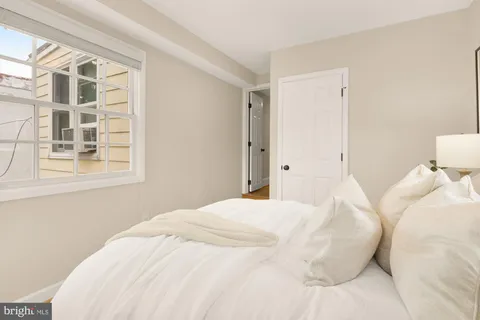 a large white bed in a white room