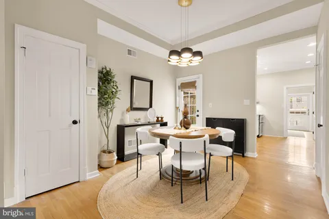 a view of a dining room with furniture and chandelier