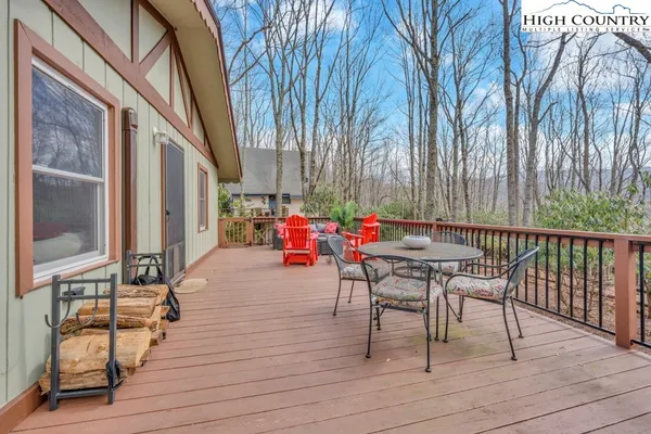 a patio with glass top table and chairs