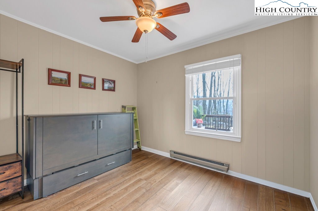 837 Pine Ridge Road Beech Mountain, NC 28604 - Photo 8 of 21 a view of an empty room with window and wooden floor