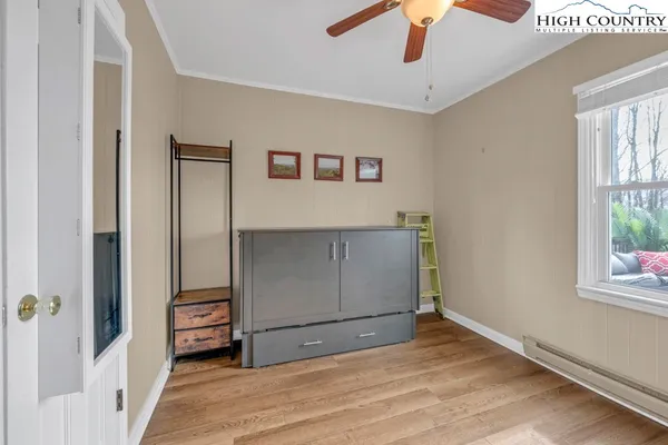 an empty room with windows and closet