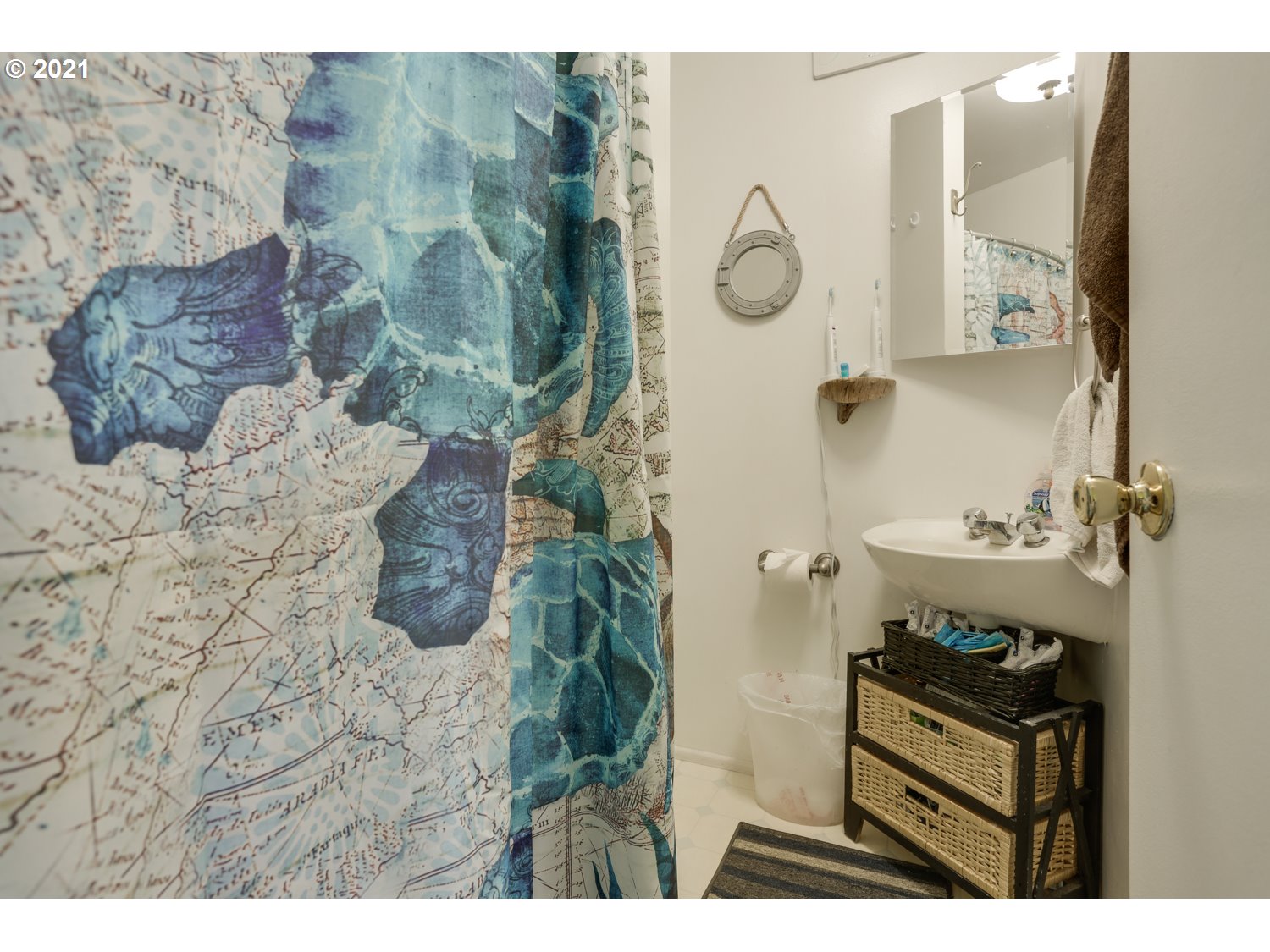 26440 Northwest Reeder Road Portland, OR 97231 - Photo 12 of 31 a bathroom with a sink and mirror