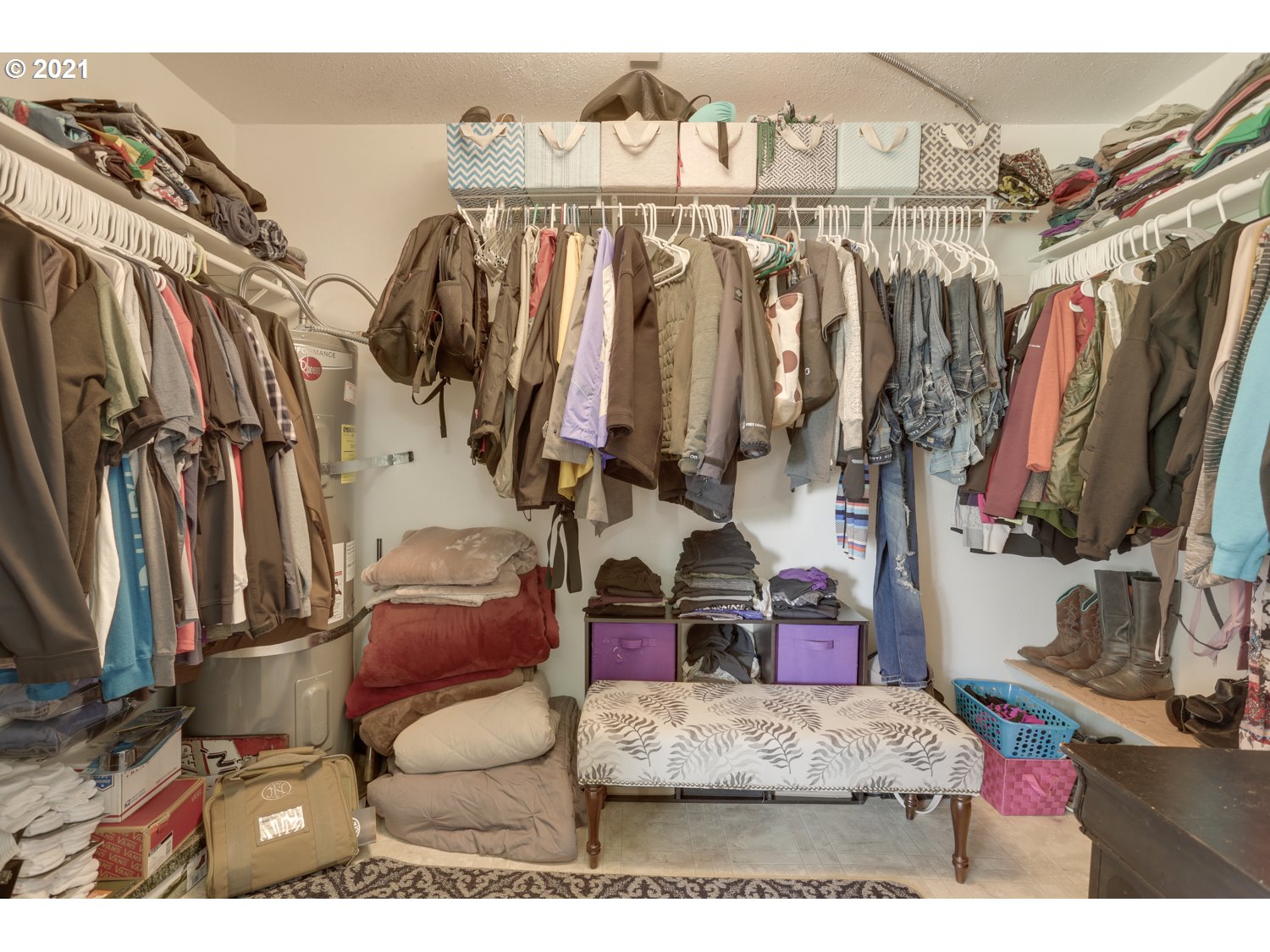 26440 Northwest Reeder Road Portland, OR 97231 - Photo 13 of 31 a view of walk in closet with clothes and shoes