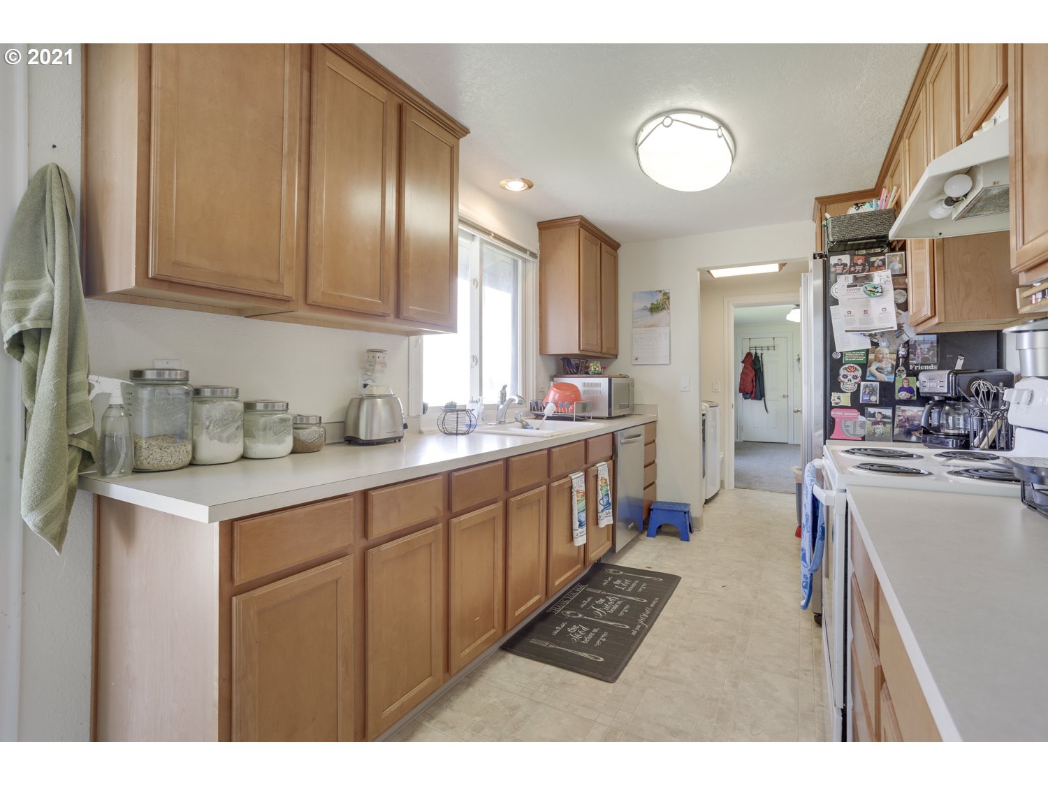 26440 Northwest Reeder Road Portland, OR 97231 - Photo 6 of 31 a kitchen with sink a counter top space and cabinets