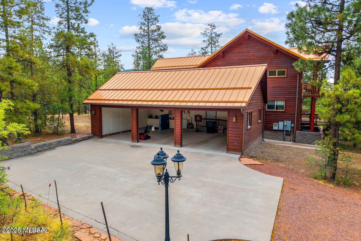 17 2195 Alpine, AZ 85920 - Photo 22 of 48 a front view of a house with a garden and patio