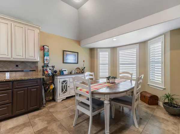 a view of a dining room with furniture and windows